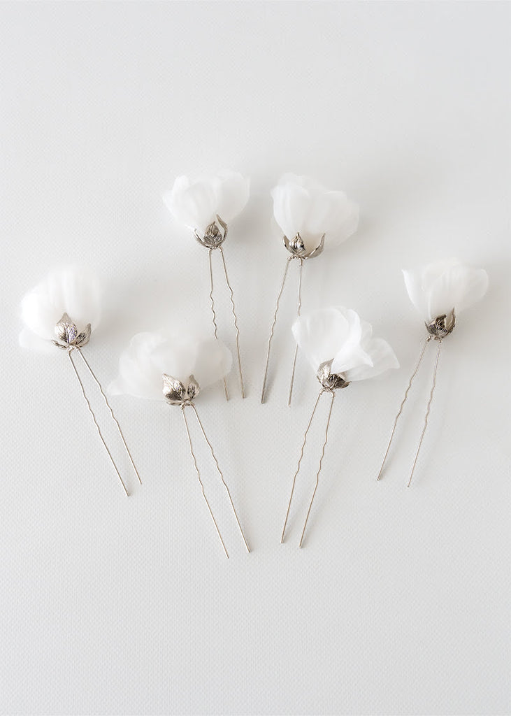 Silk flower hair pin in a set of six. A single flower on each pin with metal leaves that cup at the bottom of the flower