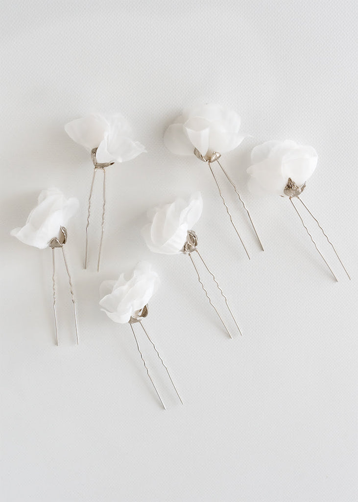 Silk flower hair pin in a set of six. A single flower on each pin with metal leaves that cup at the bottom of the flower