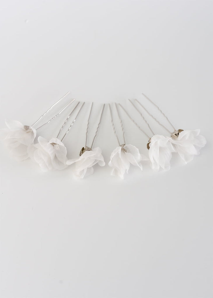 Silk flower hair pin in a set of six. A single flower on each pin with metal leaves that cup at the bottom of the flower
