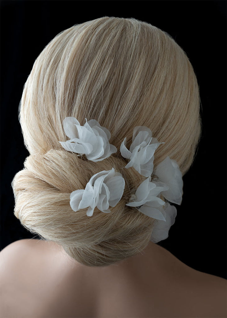 Silk flower hair pin in a set of six. A single flower on each pin with metal leaves that cup at the bottom of the flower