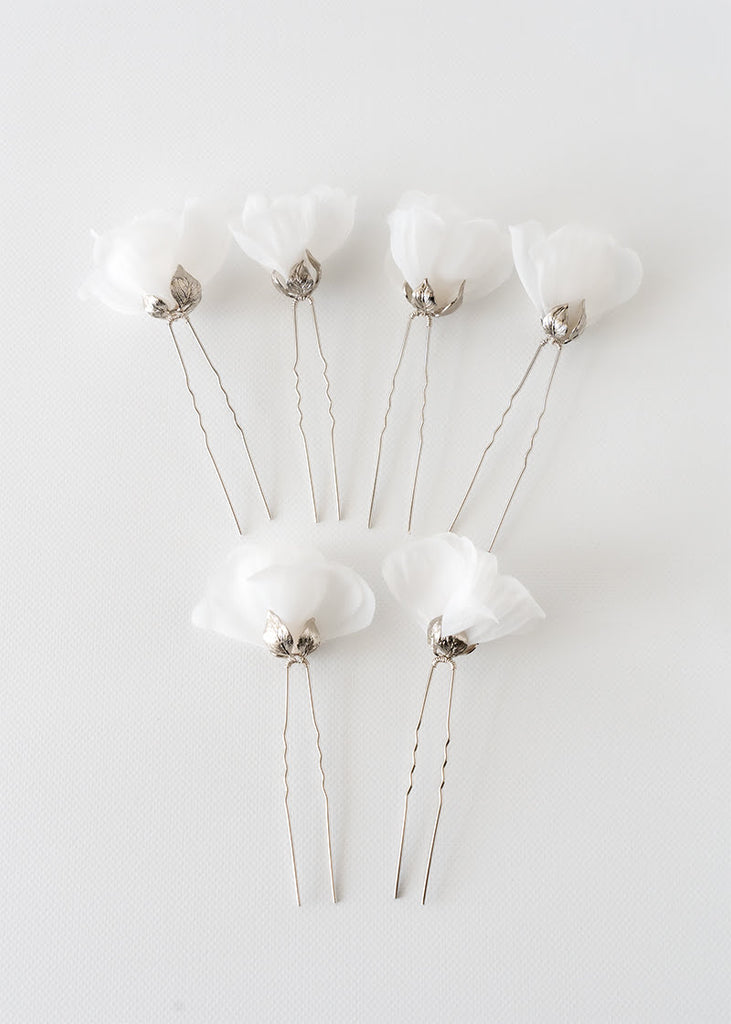 Silk flower hair pin in a set of six. A single flower on each pin with metal leaves that cup at the bottom of the flower