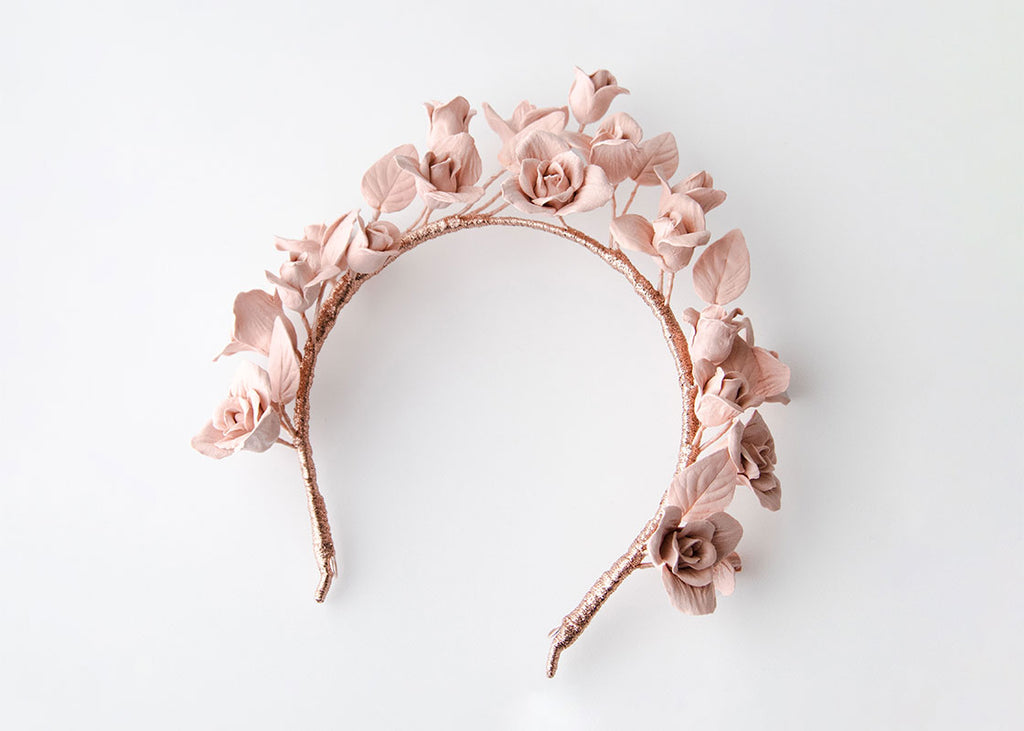 Pink roses and leaves on a headband. Custom design for Amelia.