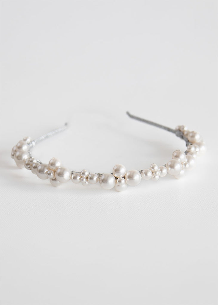 Pearl clusters in a variety of sizes place on a headband.