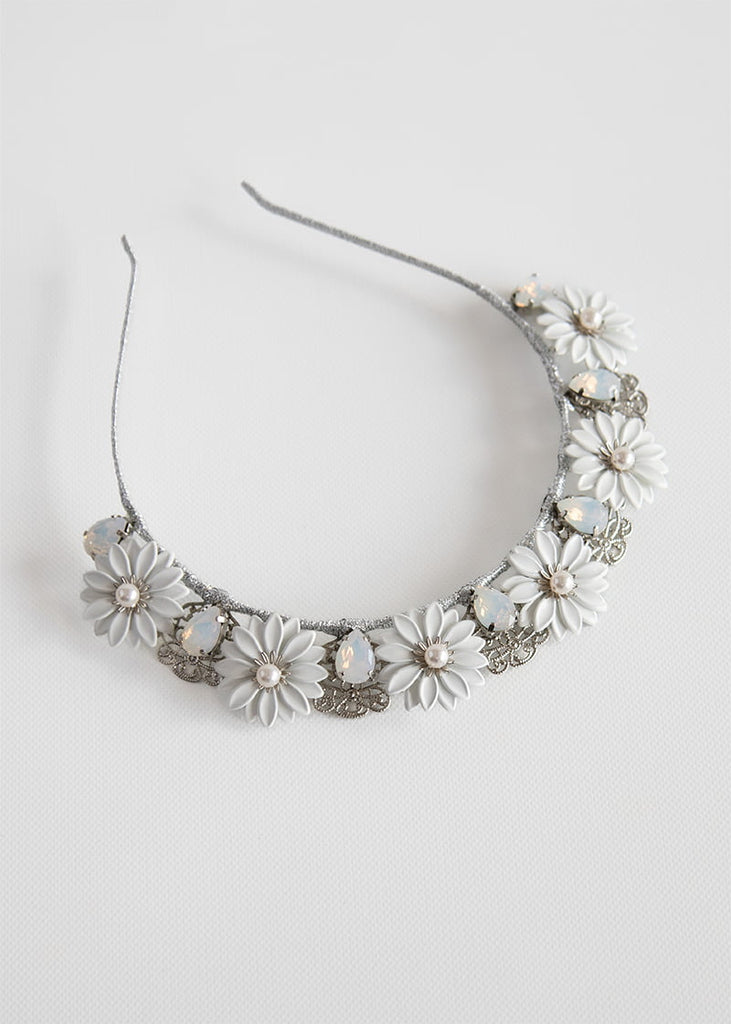 Daisy crown has pretty metal Daisy like flowers across the headband with rhinestone in between each flower and a lovely filigree piece behind the rhinestone.