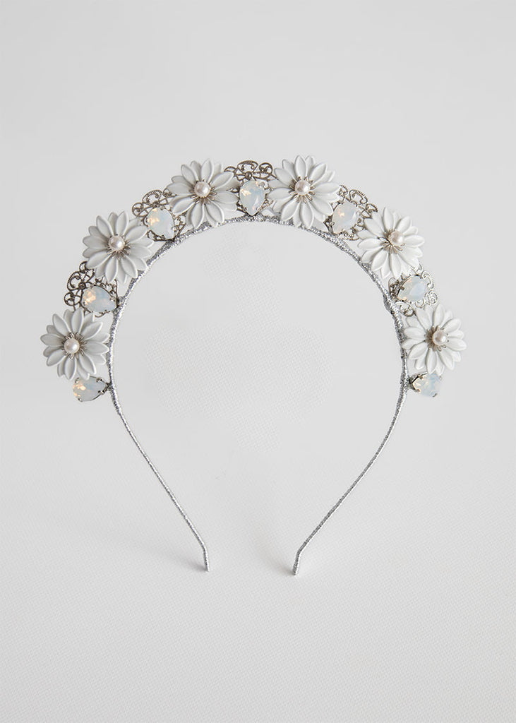 Daisy crown has pretty metal Daisy like flowers across the headband with rhinestone in between each flower and a lovely filigree piece behind the rhinestone.