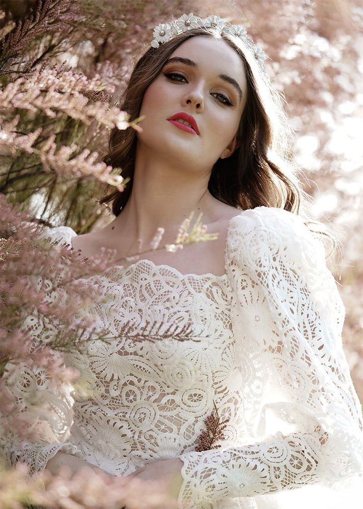 Daisy crown has pretty metal Daisy like flowers across the headband with rhinestone in between each flower and a lovely filigree piece behind the rhinestone.