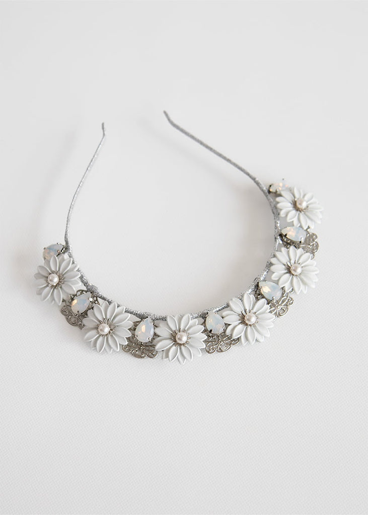 Daisy crown has pretty metal Daisy like flowers across the headband with rhinestone in between each flower and a lovely filigree piece behind the rhinestone.