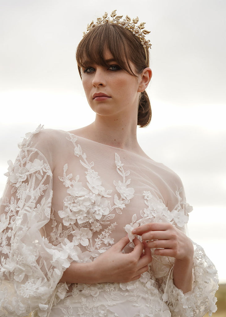 Metal leaf tiara with flowers to the bottom of the leaves.