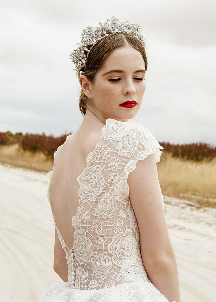 Everleigh crown has pretty filigrees with hand beading of pearls and rhinestone spread out over the headpiece.