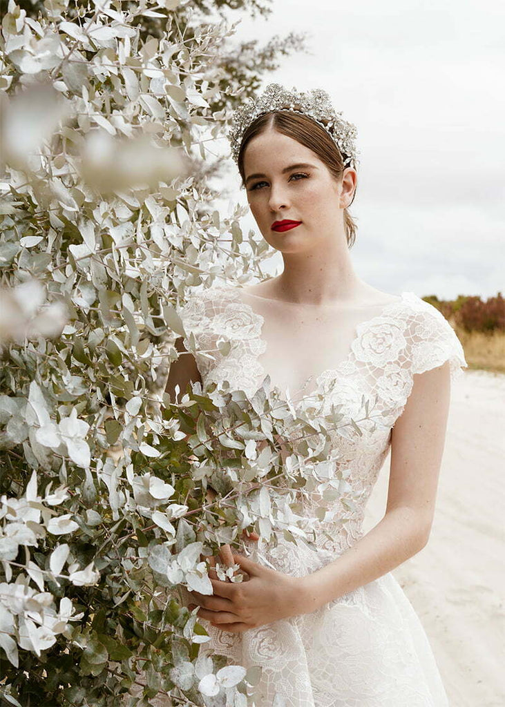 Everleigh crown has pretty filigrees with hand beading of pearls and rhinestone spread out over the headpiece.