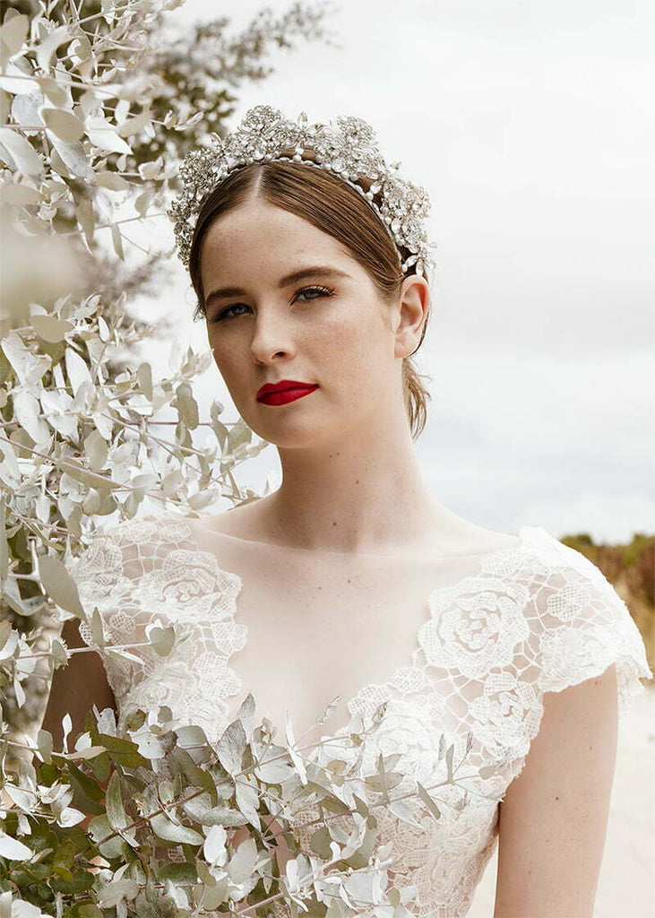 Everleigh crown has pretty filigrees with hand beading of pearls and rhinestone spread out over the headpiece.