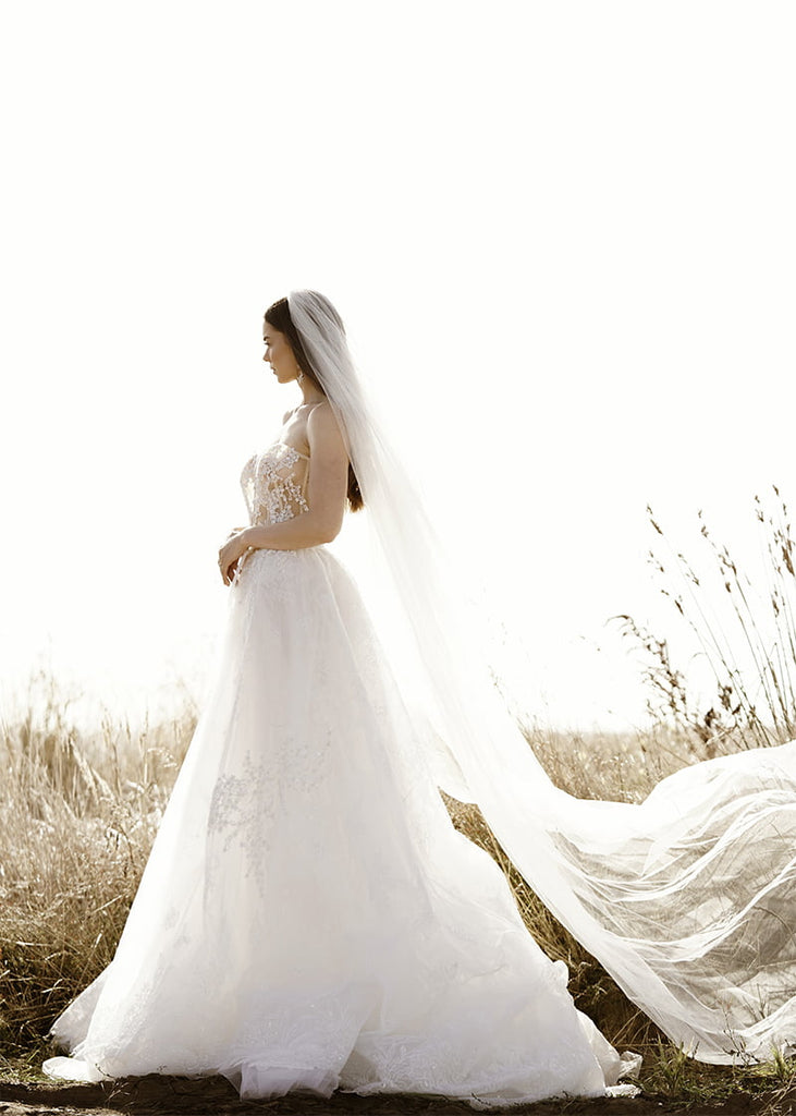 Isabel is a two tier wedding veil with a cut edge and extra long sides with a medium amount of gather.