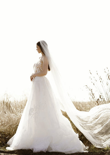 Isabel is a two tier wedding veil with a cut edge and extra long sides with a medium amount of gather.
