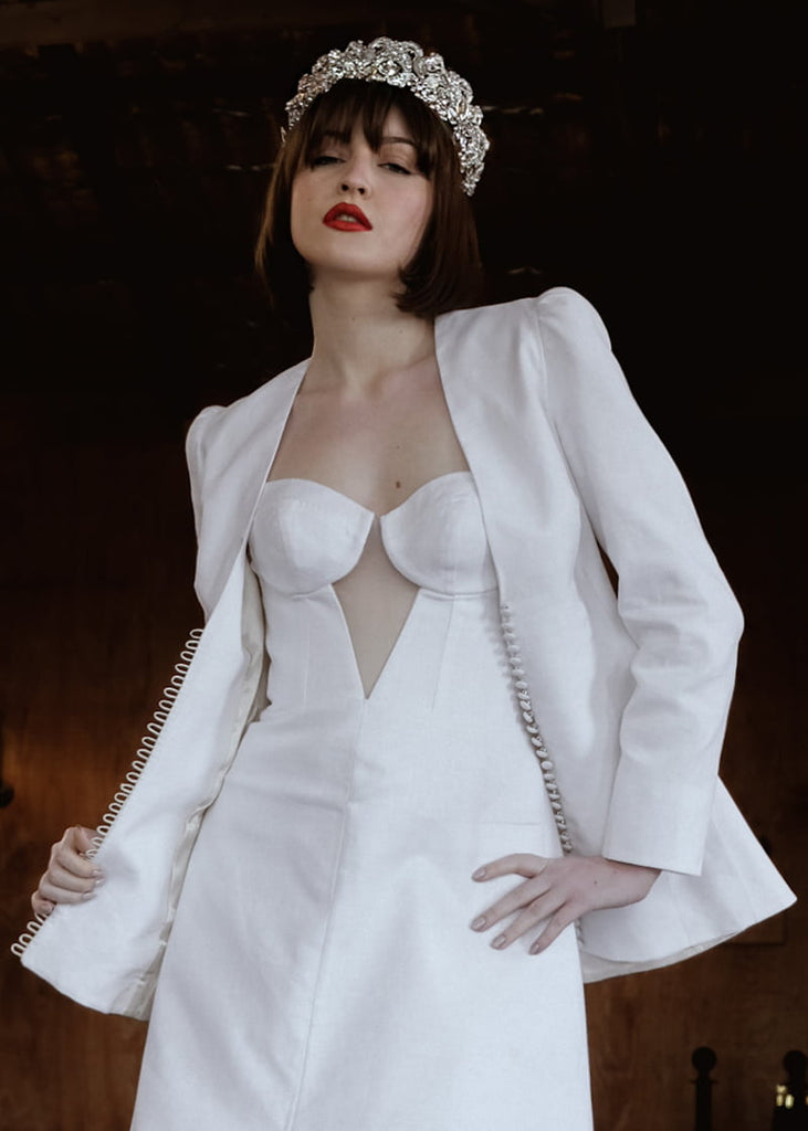 Olympia statement tiara is 6 cm tall with an abundance of hand beading of rhinestone and pearls. It has metal filigrees and leaves for the base of the design.