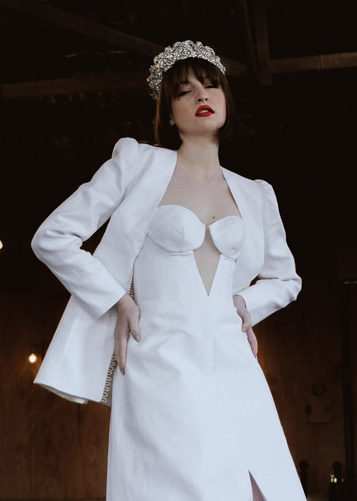 Olympia statement tiara is 6 cm tall with an abundance of hand beading of rhinestone and pearls. It has metal filigrees and leaves for the base of the design.